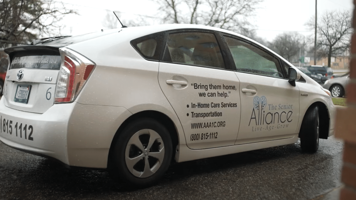 The Senior Alliance delivery vehicle with car decals of their logo and services provided